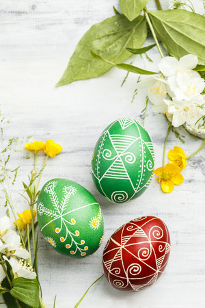 Three pysanky handmade Easter eggs. Ukrainian pysanky decorated with wax-resist dyeing technique. Holiday postcardの写真素材