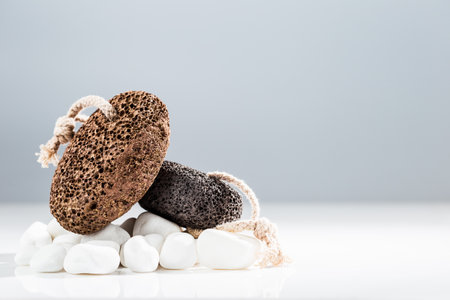 Brown and black pumice stone for home spa over white backgroundの写真素材