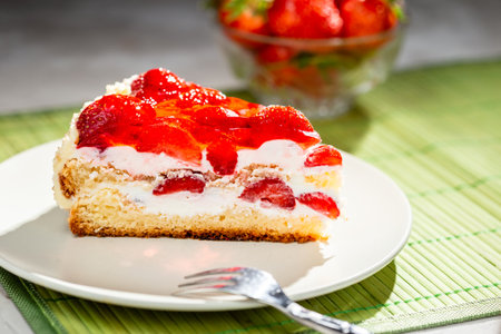 A piece of strawberry cake served on a white plate redy to eatの写真素材