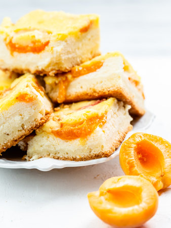 Slice of fresh baked apricot and cheese tart dessertの写真素材