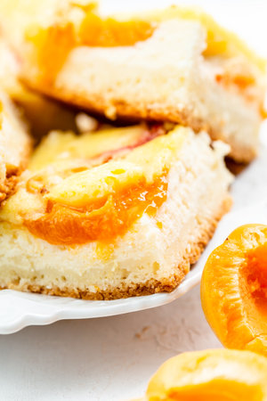 Slice of fresh baked apricot and cheese tart dessertの写真素材
