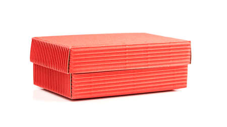 Red closed corrugated cardboard box isolated on white. Valentine's Day gift packaging conceptの写真素材