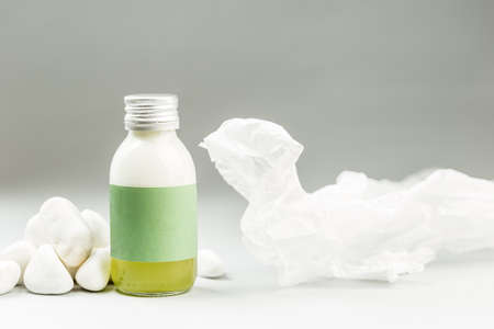 Skin Care Product in Plastic Free Packaging. Glass Bottle with Metal Cap and blank green Label on...