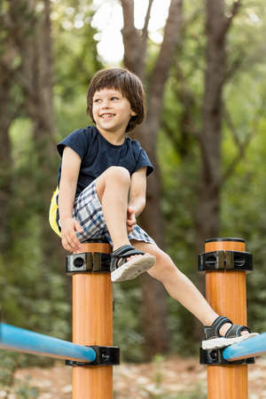 A young child having fun playing on sport equipment in a parkの写真素材