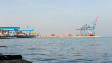 Commercial sea port in Odessa, Ukraine. March 2021. Panoramic view. Sea transport, container cranesの写真素材