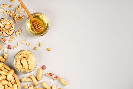 Peanut butter with honey flavour. Flat lay on grey background, copy space for textの写真素材