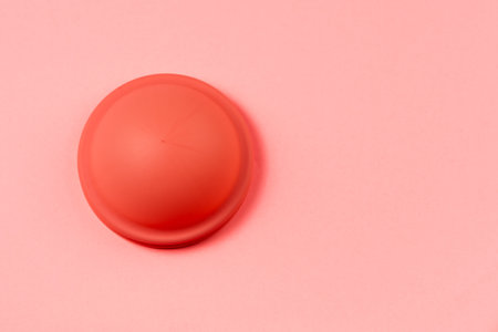 Menstrual Disk, reusable menstrual eco friendly product, pink background with copy spaceの写真素材