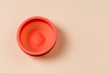 Menstrual Disk, reusable menstrual eco friendly product, beige background with copy spaceの写真素材