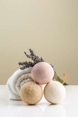 Homemade salt bath bombs with dry lavender flowers and white towel. Natural cosmeticsの写真素材