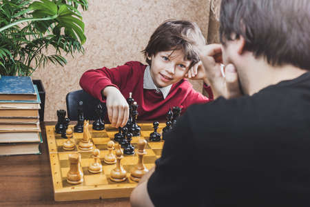 Father and son playing chess at home. Family leisure game activitiesの写真素材