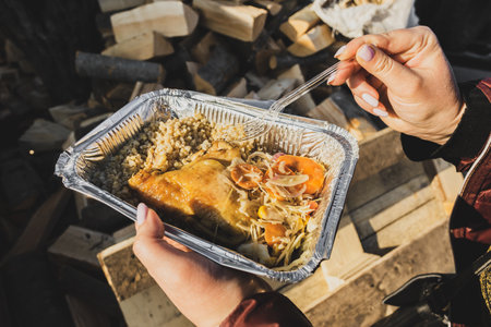LVIV, UKRAINE - March 23, 2022: A portion of a free meal for the refugees at Lviv Central Railway Station. People make a stop in Lviv while escaping from the russian war against Ukraine.のeditorial素材