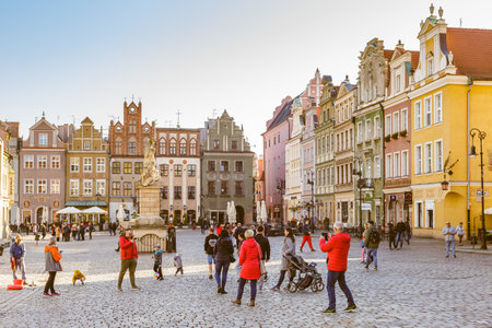 Poznan, Poland - 30 October, 2021: Tourists are walking on Stary Rynek - the Old Market Square in Poznan, Poland. Beautiful European architecture on the backgroundのeditorial素材