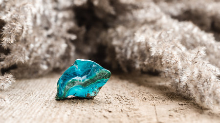 Tumbled Cyan Colored Chrysocolla Phyllosilicate Mineral on Wooden Backgroundの写真素材