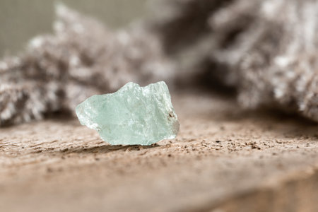 Rough Uncut Pale Blue Aquamarine Gemstone on Wooden Background. Healing Breath Stone is Believed to Cure Respiratory Problemsの写真素材