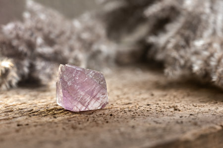 Fluorite or Fluorspar Mineral Crystal Gem Stone Lit Up from behind on Wooden Background. Healing Crystal Used for Spiritual Detoxificationの写真素材