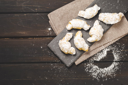 Traditional Jewish Rugelach or Kifli Crescent Rolled Cookies Covered with Sugar Icing. Freshly Home Baked Shortcrust Pastry Croissants Confectionの写真素材