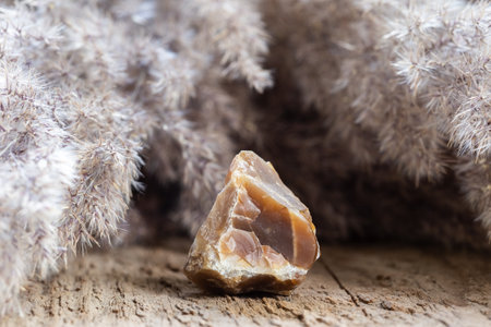 Closeup of Raw Brown Natural Chalcedony Stone Specimen on Wooden Background
