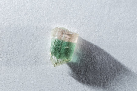 Raw Pink and Green Watermelon Tourmaline Crystal on White Background in Harsh Lightの写真素材