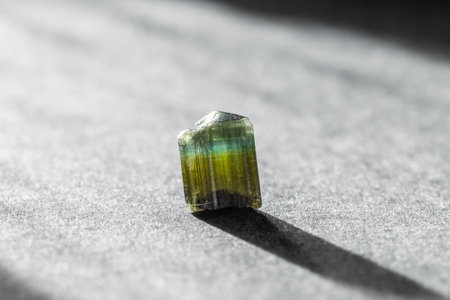 Raw Blue and Green Tourmaline Crystal on Dark Background in Studio Lightの写真素材