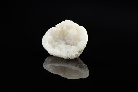 White Raw Apatite Crystal Geode with Crystalline Close Up on Black Background with Reflectionの写真素材