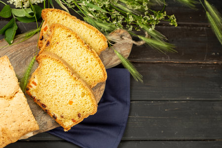 Tasty Sliced Home Baked Bread on Black Wooden Background with Copy Spaceの写真素材