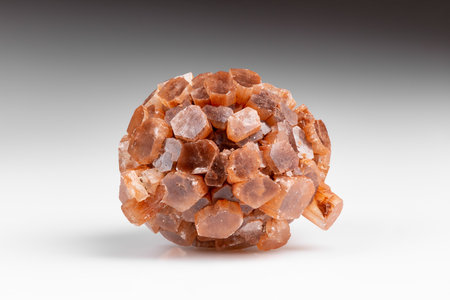 Radiating Group of Prismatic Crystals of Raw Aragonite Mineral Gem Stone on Grey Background with Shadow. Aragonite Sputniks or Twinned Crystals Macro Shot with Stacking.の写真素材
