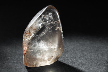 Tumbled Smoky Quartz Crystal on Dark Background Back Lit Showing its Transparencyの写真素材