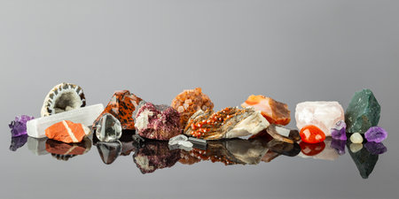 Wide Banner with a Group of Colorful Stones and Minerals Arranged in a Row on the Reflective Surface. The Crystal Collector Displayの写真素材