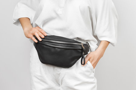 Black Leather Waist Bag on a Woman Wearing White Jeans and Shirt. Handmade Leather Accessories Goodsの写真素材
