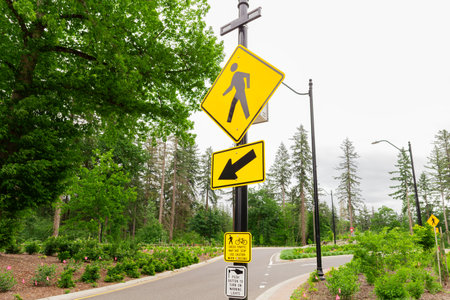 The Iconic Yellow Pedestrian Road Sign at a Local road in the Forest Area. Prioritizing the well-being of pedestrians, fostering a safer and more inclusive transportation environment.の写真素材