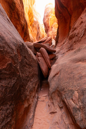 Two large rocks face each other to create a slot canyon inside the Fiery Furnace in Arches National Park near Moab, Utah.の写真素材