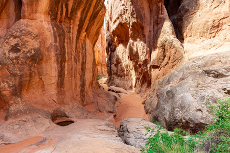 Narrow Sandstone Desert Rock Canyon with Steep Walls and Water Pool in Fiery Furnace Hiking Trail, Arches National Park, Utah, United Statesの写真素材