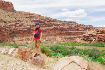 Young Hiker Boy Standing among Rock Formations in Utah, United Statesの写真素材