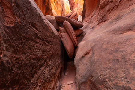 Two large rocks face each other to create a slot canyon inside the Fiery Furnace in Arches National Park near Moab, Utah.の写真素材