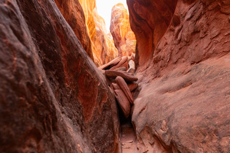 Two large rocks face each other to create a slot canyon inside the Fiery Furnace in Arches National Park near Moab, Utah.の写真素材