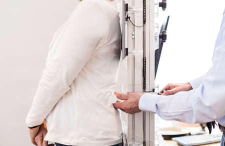 Measuring the back of a customerの写真素材