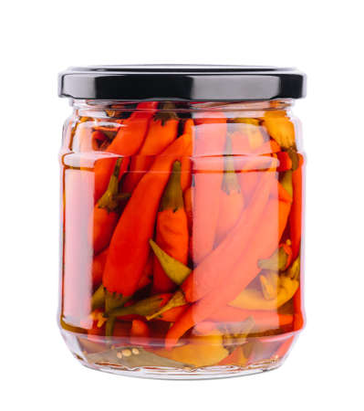 Glass jars with pickled chili peppers on white backgroundの写真素材