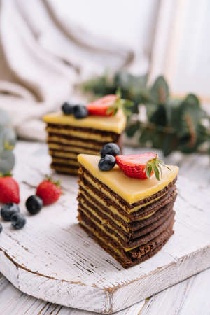 Delicious fresh chocolate cake with berries on wooden tableの写真素材