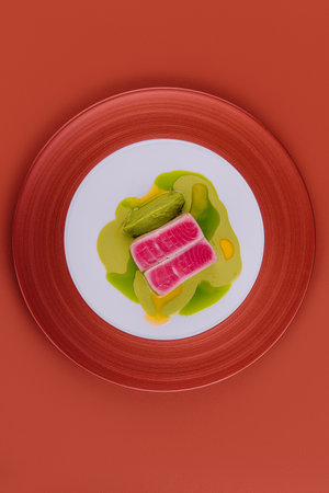 Tuna sashimi and pea puree on plateの写真素材