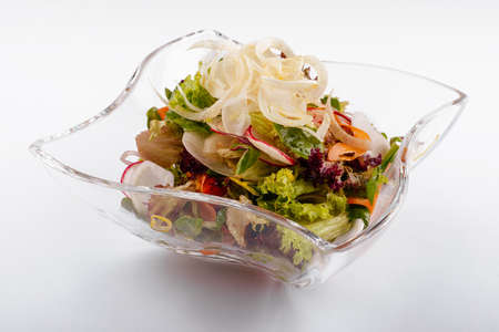 Radish salad in glass bowl isolated on whiteの写真素材