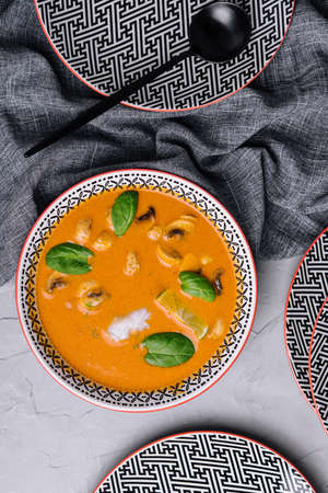pumpkin cream soup with fried mushrooms and fresh basilの写真素材
