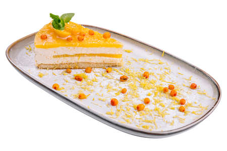 Cheesecake with orange chips on plateの写真素材
