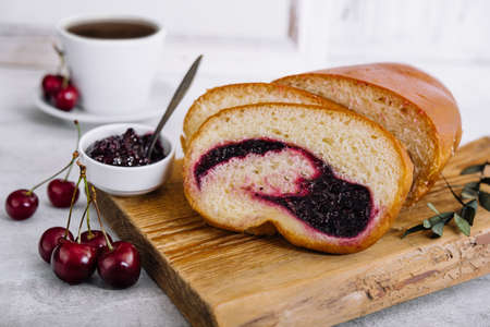 Homemade sweet cherry loaf cake on boardの写真素材