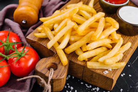 French fries on wooden table close upの写真素材
