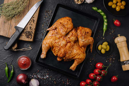 Roasted chicken on wooden cutting boardの写真素材
