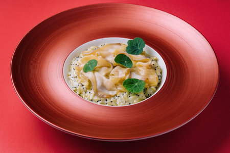 white fish fillet served with steamed rice in a beautiful red bowlの写真素材
