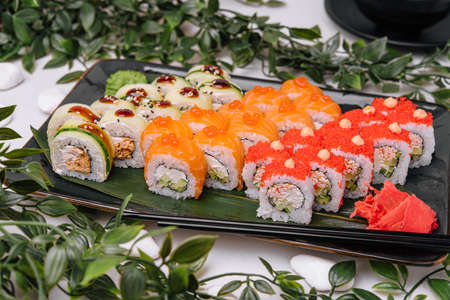 Sushi rolls on a black plateの写真素材