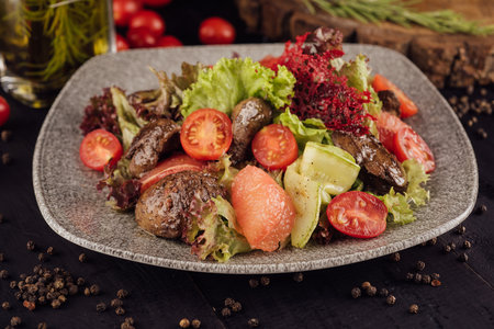 Meat and vegetable salad on plateの写真素材