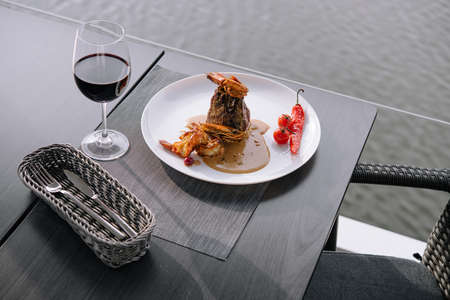 A delicious shrimp scampi dish with red wineの写真素材