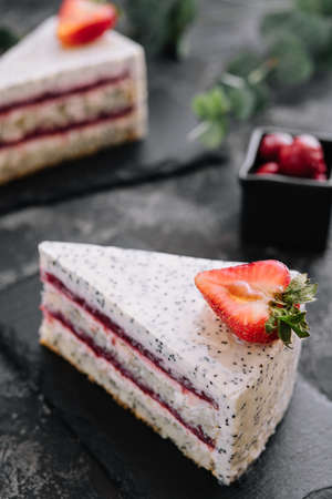 Piece of strawberry cheesecake on black boardの写真素材